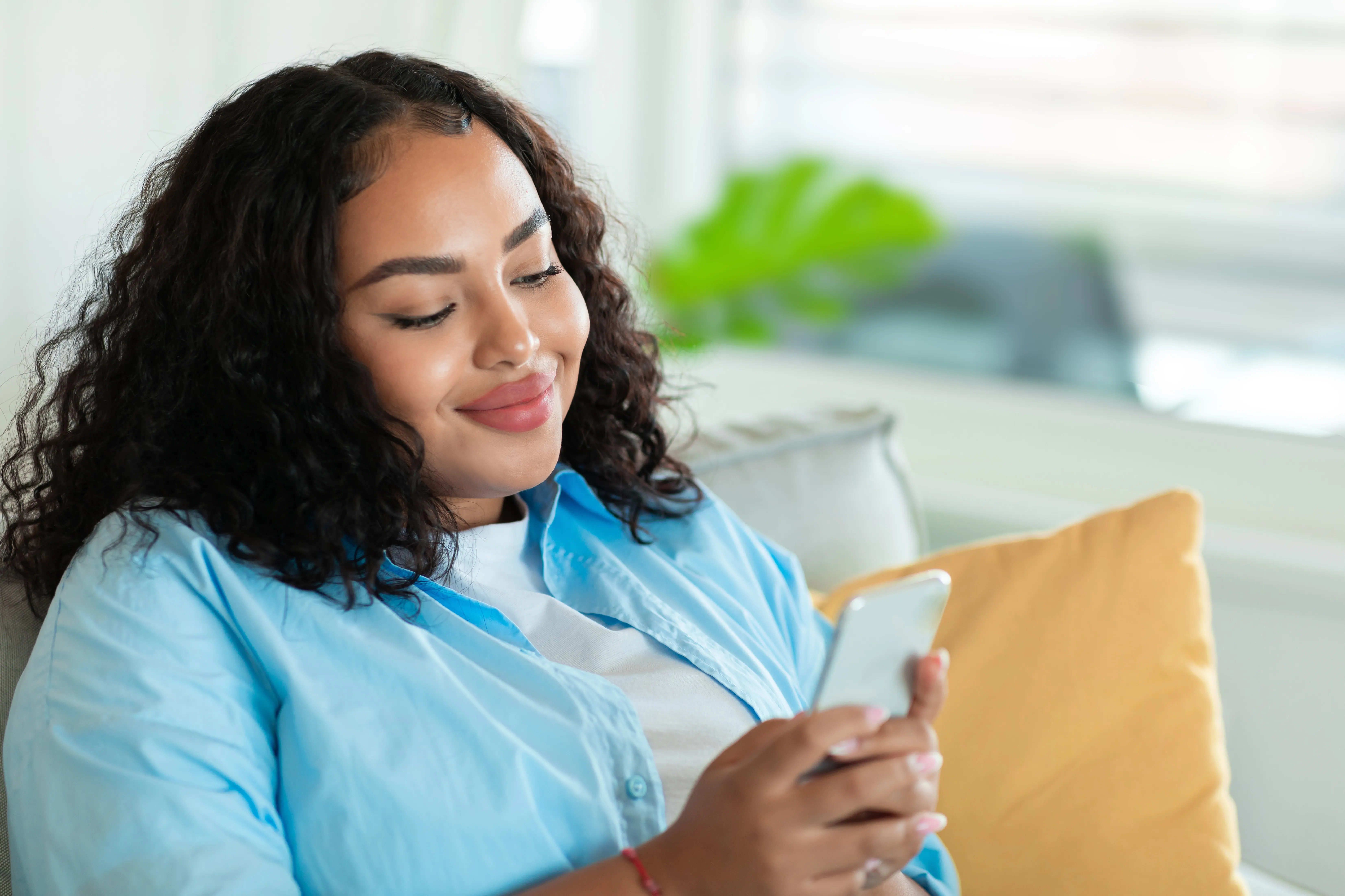 A woman reading a message on her phone